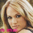 Pixelated close-up of a person with light brown hair and fair skin, wearing pink text overlay at bottom left.