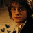 Pixelated image of a person with dark hair and glasses on left, bright pink background with repeated text on right.