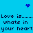 Blue background with pixelated text repeating 'Love is....... Whats in your heart' and three blue dot clusters forming a heart shape.