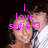 Pixelated image of a person with dark hair and light skin, overlaid with bright pink text reading 'i love sofia<3' against a black background.