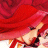 A pixelated figure with long red hair, wearing a dark top and light-colored shorts against a red background.