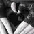 Black and white pixelated icon featuring a stylized heart shape with rounded top, positioned above two diagonal white stripes on dark background.