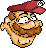 Pixelated character with brown hair and beard, wearing a red cap with white checkered detail on the brim, wide eyes, and a smiling mouth against gray background.