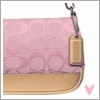 A pink, green, and blue patterned Coach-style wristlet with a tan leather bottom and metal clasp, shown in three color variations with small heart icons below each.
