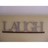 A static pixelated image shows the word 'LATCH' in stylized uppercase letters on a light brown background with horizontal bands.