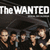 The WANTED text appears above a group of men holding guns in a dark, stylized composition with repeated elements.