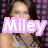 A pixelated image of a person with long brown hair wearing a light gray tank top against a purple and black polka-dot background, featuring text overlays.