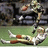 Pixelated image of a football player lying on grass with text overlays reading "Reggie," "Gots," and "Hops!!!!!" against black background.