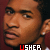 A 4x4 contact sheet of animated frames showing a person with short hair and earrings against a dark red background, each frame displaying the text "USHER" in white or red lettering.