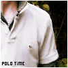 A close-up of a person wearing a white polo shirt with black trim on the collar and sleeves, standing outdoors.