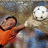 Pixelated image of a person in an orange shirt reaching toward a soccer ball, with text overlays on dark brown background.