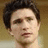 Pixelated portrait of a person with dark hair on left, blue background with white text 'Kyle XY' on right.