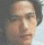 Four pixelated portrait of a person with dark hair, each showing different facial expressions and head positions against varied backgrounds