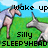 Pixelated image of two cartoon unicorns on a green field under a blue sky with clouds, with text reading 'wake up', 'Silly', and 'SLEEPYHEAD' in black block letters.