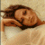 A 50x50 pixel animated contact sheet showing two frames of a buddy icon with a person lying down on the left and green text on a dark background on the right.