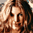 Pixelated image of a woman with long curly brown hair wearing a black bikini top and bottom, showing her torso and face from multiple angles.