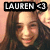 A pixelated image shows a person with long brown hair and light skin, overlaid by a black banner containing the text 'LAUREN' in white block letters.