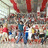 A static image divided into four quadrants with red, gray, and pixelated sections containing text and a blurred crowd scene.