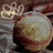 A pixelated static image shows a large round object with a textured surface and a smaller decorative element above it against a blurred background.