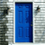 A static image of a blue door with six panels, framed by light gray siding, with a small dark object on the right side.