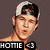 Pixelated image of a person wearing a white and black baseball cap, with visible text 'HOTTIE' and '<3' at the bottom.