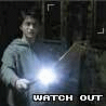 A person in a gray hoodie holds a glowing wand-like object with bright light, while text below reads "WATCH OUT"