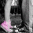 A static pixelated image shows a dark cylindrical object with a metallic top, a pink glowing shape below it, and a light vertical beam on the left side.