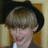Pixelated image of a person with light brown hair and dark hat, next to pixelated text on white background.