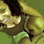 Pixelated static image of a character with dark hair and light skin, wearing a green garment, set against a green background.