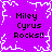 Purple background with white pixelated snowflake border and four identical text blocks reading "Miley Cyrus Rocks!!" in black pixelated font.
