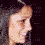 A woman's profile face with dark hair and a smile, surrounded by white stars that increase in number across frames.