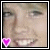A pixelated close-up of a person's face with two side-by-side frames showing slight variations in facial expression and a pink heart symbol on the left frame.