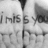Black-and-white photo of hands with 'i miss you' tattooed on knuckles, red pixelated text listing self-deprecating phrases and a question about hope and dreams.