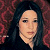 Static pixelated image of a person with long dark hair against a red and black patterned background, rendered in low resolution with visible dithering and color blending.
