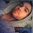 Pixelated image of a person with light skin tone lying down, eyes closed, and mouth slightly open against a muted background.