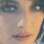 A pixelated close-up of a person's face showing eyes, nose, and lips with visible skin tones and dark hair on the right side.