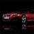 A red vehicle with visible headlights and wheels on a dark background, appearing as a static digital image with pixelated details.