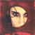 Pixelated close-up of a light-skinned face with dark hair against a reddish-brown background, showing eyes and part of the nose.