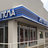 Static image of a building facade with columns and a blue roof, partially obscured by pixelation.