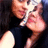 Pixelated close-up of two figures in a kiss, one with light hair and the other with dark hair, against a dark background.