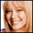 pixelated images showing a person with light brown hair and a purple top, with text fragments reading 'Cheaper by the dozen' in various positions