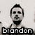 A black-and-white pixelated image of a man with a beard and short hair, displayed in a with text labels
