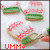 Pixelated cookies with red and green icing on a white background, text 'YUM' visible at bottom.