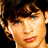A 4-frame contact sheet of a Smallville promotional icon featuring a character portrait, show title text, broadcast time information, and the WB network logo across four quadrants.