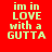 Red background with repeated yellow text "im in LOVE with a GUTTA" in pixelated font across multiple