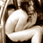 Static grayscale icon of a person in an intimate pose with another figure, rendered as pixelated low-resolution art with high contrast between light and dark tones.