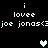 Pixelated text and heart symbols on black background with animated heart color changes.