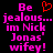 Pixelated text in bright pink and red on black background, with a heart symbol replacing the 'o' in 'Be'.