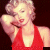 A pixelated image of a woman in a red halter dress with blonde hair, shown across four where her head position shifts slightly left to right