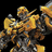 Pixelated figure in dynamic pose with golden-yellow and dark gray tones against black background, arms raised and legs bent as if mid-action.